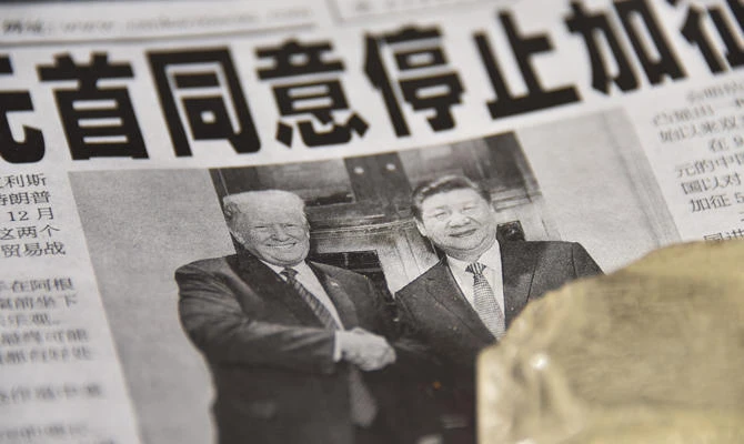 A newspaper featuring a front page story about the meeting between US President Donald Trump and Chinese President Xi Jinping as seen at a news stand in Beijing on December 3, 2018. (AFP / GREG BAKER)