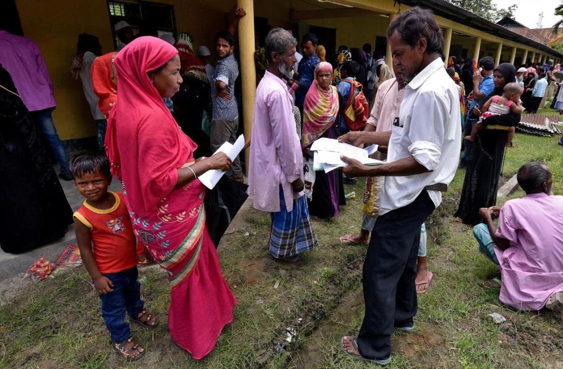 Villagers wait outside the National Register of Citizens (NRC) center to get their documents verified by government officials, at Mayong Village in Morigaon district, in the northeastern state of Assam, India. (Reuters)