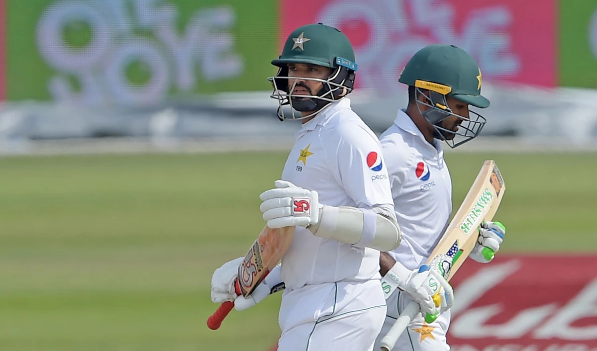 Pakistani batsmen Asad Shafiq, right, and Azhar Ali run between the wickets during the third day of the third and final Test cricket match between Pakistan and New Zealand in Abu Dhabi on Dec. 5, 2018. (AFP)