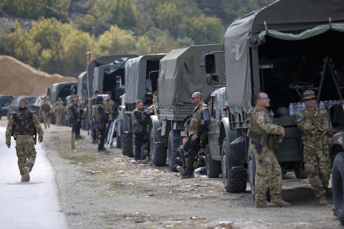 Soldiers of NATO-led peacekeeping force KFOR take a break by the side of the road in the village of Kosterc, Kosovo. Serbia’s prime minister warned that the formation of a Kosovo army could trigger Serbia’s armed intervention in it’s former province. (AP Photo)