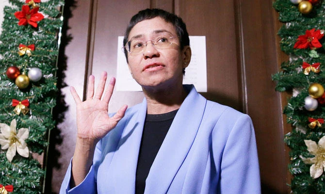 Maria Ressa, CEO of Rappler, an online news service who has been critical of the government of Philippine President Rodrigo Duterte, gestures as she talks with reporters after posting bail at the Pasig Regional Trial Court in metropolitan Manila, Philippines, Monday, Dec. 3, 2018. (AP)