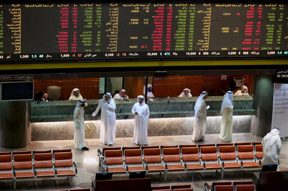 Kuwaiti traders follow the stock market at the Kuwait Stock Exchange (KSE) in Kuwait City. (AFP)