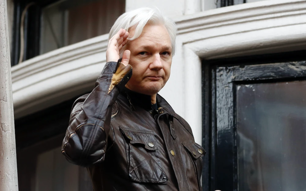 In this file photo, WikiLeaks founder Julian Assange greets supporters from a balcony of the Ecuadorian embassy in London. (AP)