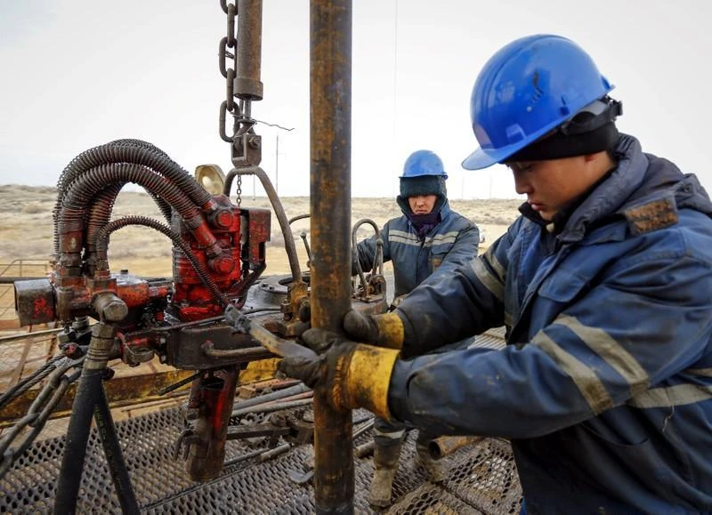 Oil is Kazakhstan’s chief export and the country’s central bank said it expects the price of Brent crude oil to average $60 a barrel next year. Above, workers at an oil well in southern Kazakhstan. (Reuters)