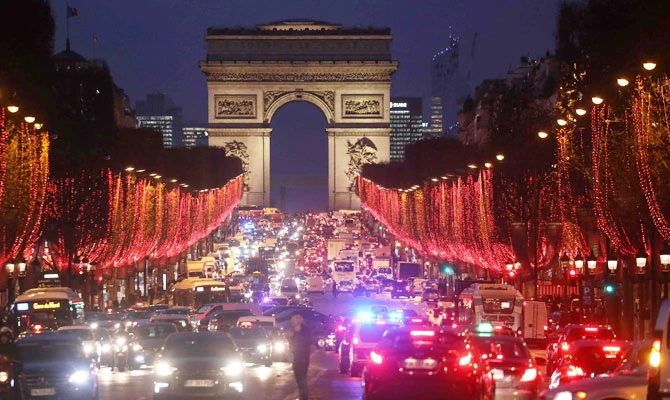 Cars drive on the Champs Elysees, on December 7, 2018 in Paris, one day before the 4th nationwide mobilisation by the Yellow vests (gilets jaunes). (AFP)