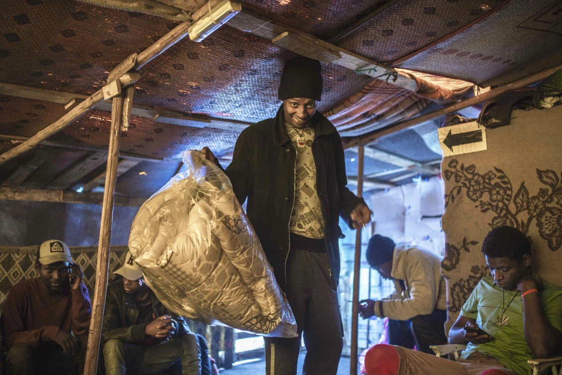 Rising numbers of migrants live in the makeshift camp that sprung up on a soccer field near a busy Casablanca bus station, where they are bedded down under tents or shacks built from plastic and wood. (AP)