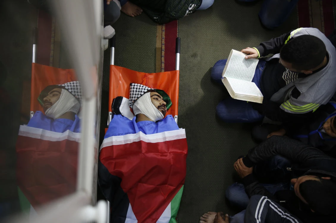 In this Tuesday, Dec. 4, 2018 file photo, Palestinians pray by the body of Mohammed Habali 22, during his funeral in the Tulkarem refugee camp near the West Bank city of Tulkarem. (AP)