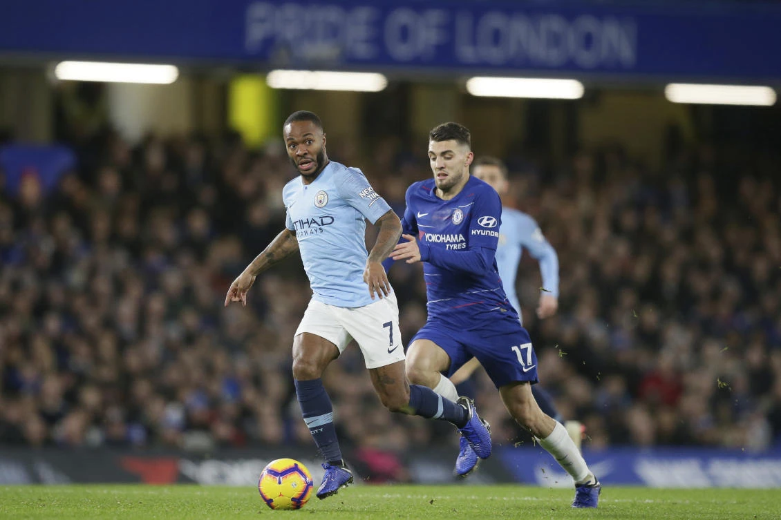 Manchester City's Raheem Sterling, left, runs with the ball following by Chelsea's Mateo Kovacic during their Premier League match between Chelsea at Stamford Bridge in London. (AP)
