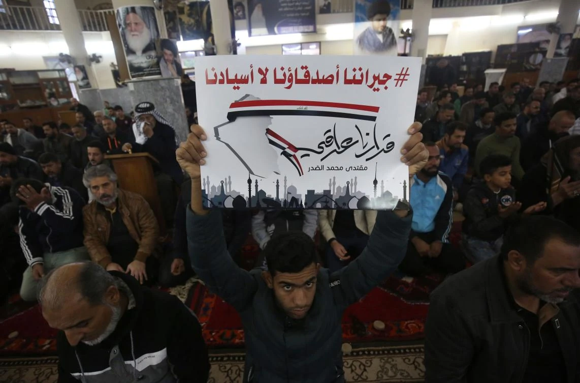 The sign in Arabic reads: “Our neighbors are our friends but not our masters. Our decision is an Iraqi decision” Shiite cleric Moqtada Sadr ordered followers in prayer today in the mosques of Iraq in order to “speed up the formation of the Iraqi government away from the intervention of neighboring countries.” (AFP)