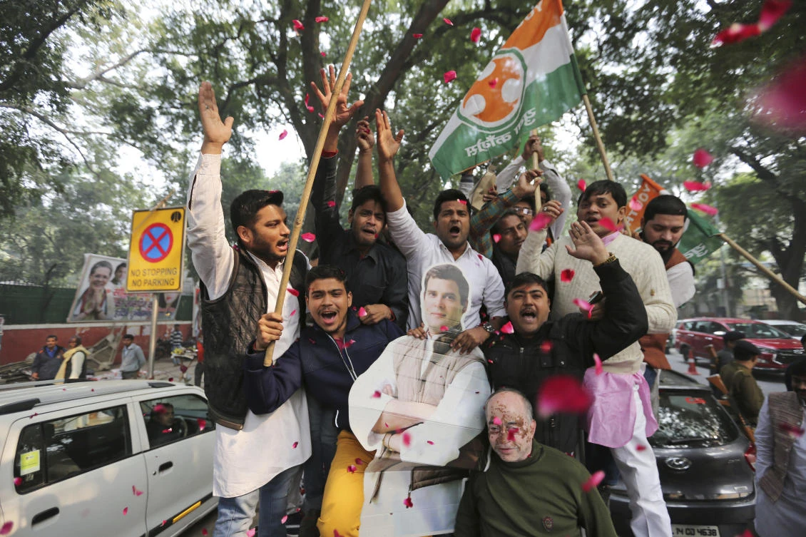 Congress party supporters hold a cut-out of party President Rahul Gandhi and celebrate outside the party headquarters in New Delhi, India, Tuesday, Dec. 11, 2018. The Congress party won in the states of Chhatisgarh and Rajasthan, while it was in a close fight with the Bharatiya Janata Party in Madhya Pradesh state. (AP)