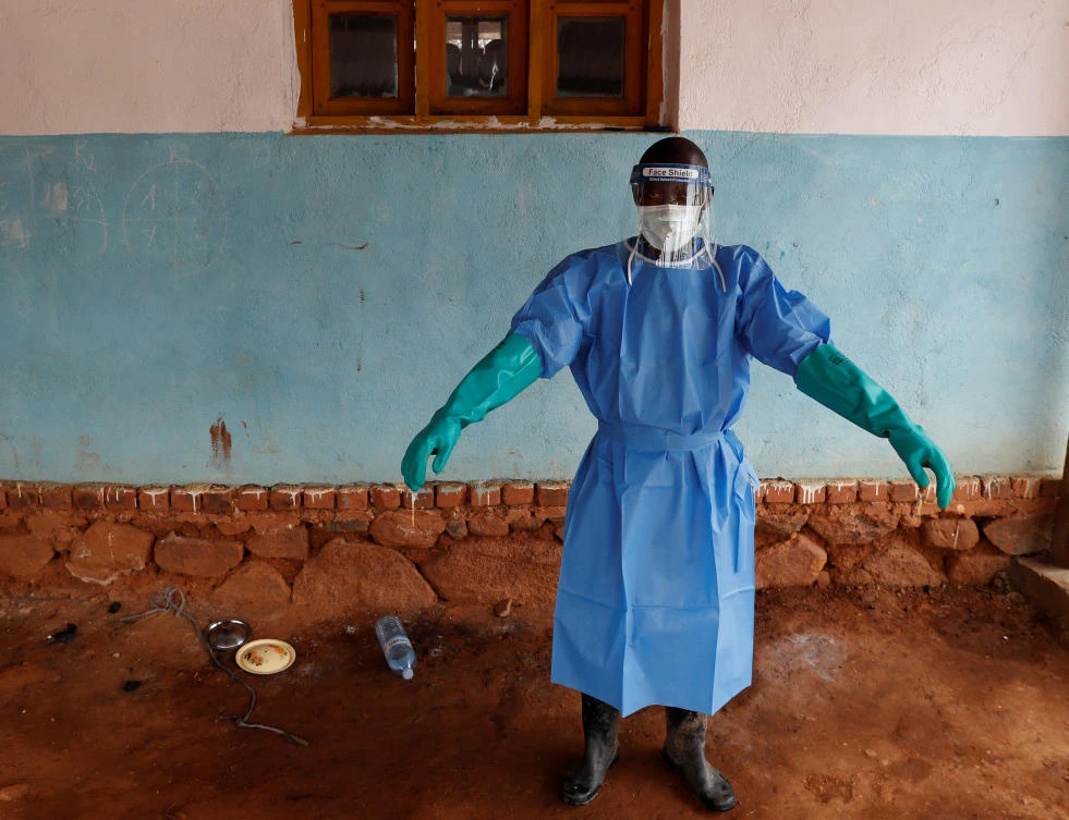 A healthcare worker stands after cleaning a room after an Ebola patient stays in a hospital in Bwana Suri, Ituri province of Democratic Republic of Congo, December 10, 2018. (Reuters)