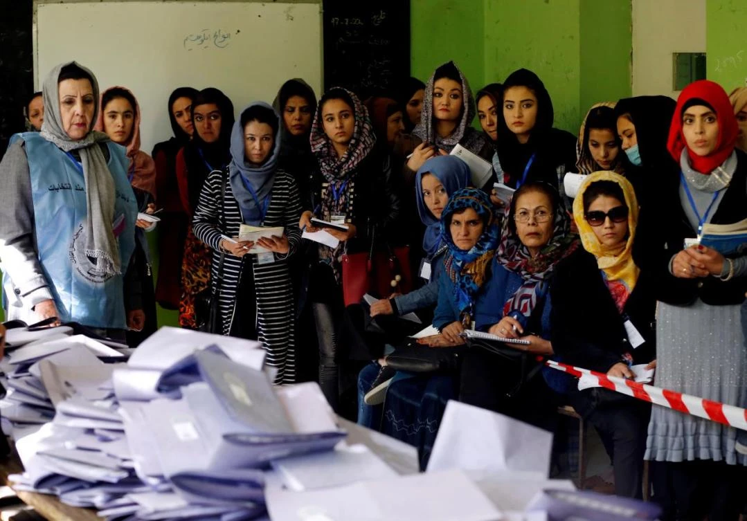 Election observers watch the counting of ballots during parliamentary elections at a polling station in Kabul, in October. (Reuters)