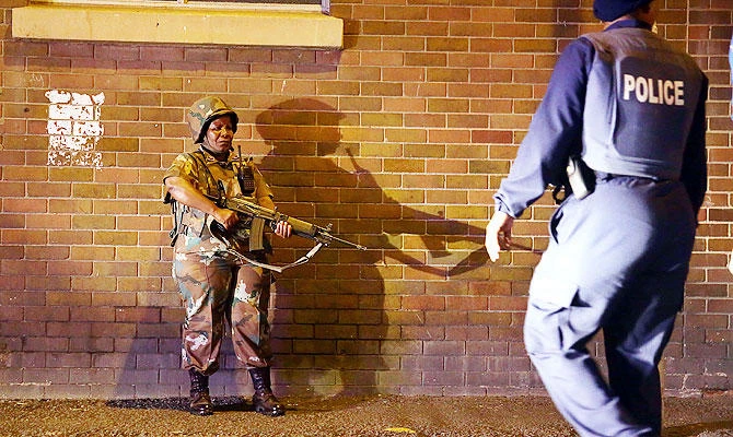A member of the South African National Defense Force (SANDF) stands guard in central Durban, South Africa. (AFP)