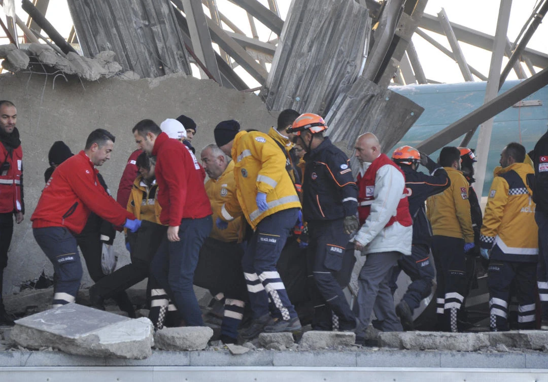 Members of rescue services assist victims at the scene of a train accident in Ankara, Turkey. (AP)