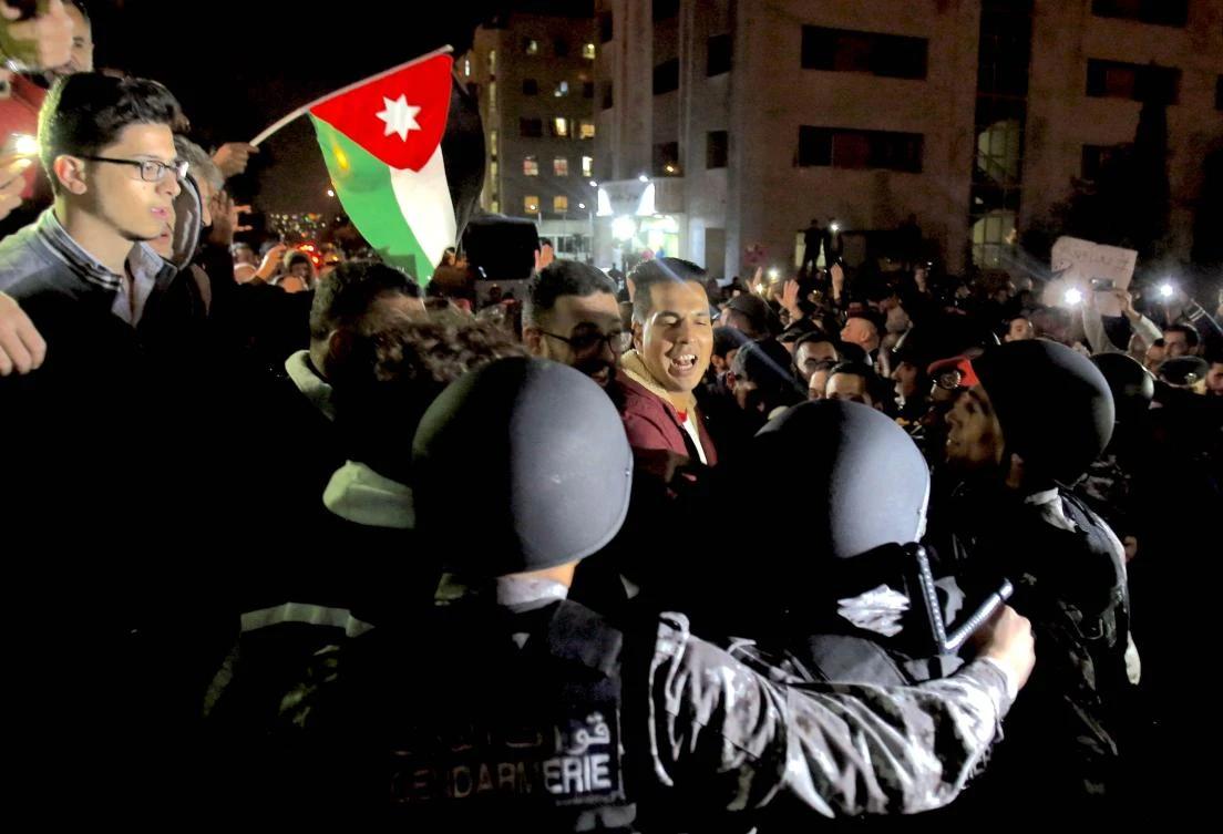 In this file photo, Jordanian protesters scuffle with riot police during a demonstration against the government's decision to raise taxes in the capital Amman. (AFP)
