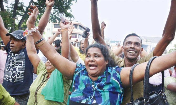 Supporters of ousted Prime Minister Ranil Wickremesinghe celebrate outside the Supreme Court premises. (Reuters)