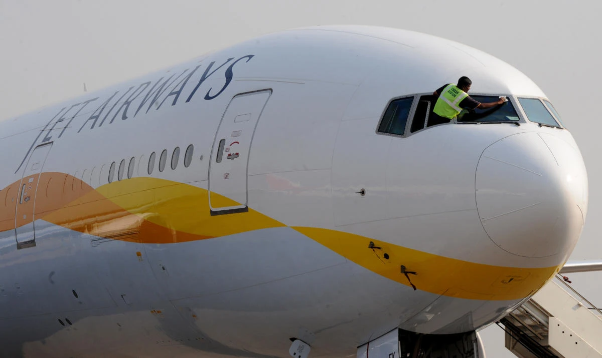 An Indian flight technician cleans the front windows of a Jet Airways Boeing aircraft. (AFP)