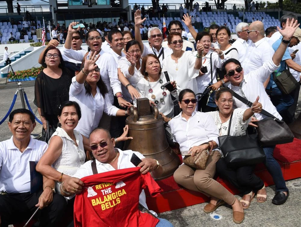 The town’s streets were crowded with people and vendors selling T-shirts saying “Balangiga bells finally home.” (AFP)