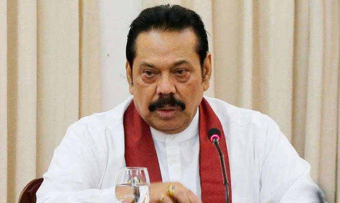 In this Nov. 3, 2018 file photo, Sri Lanka's then appointed prime minister Mahinda Rajapaksa speaks to members loyal to him at his office in Colombo, Sri Lanka. (AP)