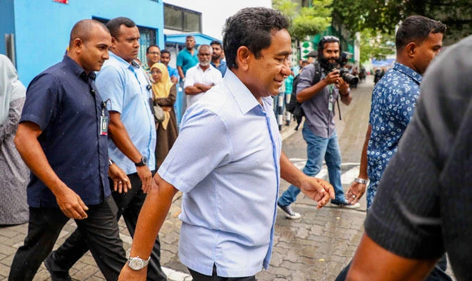 In this Sept. 23, 2018 photo, Maldivian president Yameen Abdul Gayoom, center, leaves a polling station after casting his vote during presidential election day in Male, Maldives. (AP)