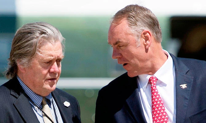 In this file photo taken on April 28, 2017, US Interior Secretary Ryan Zinke (R) talks with White House Chief Strategist Steve Bannon at Andrews Air Force Base, Maryland. (AFP)
