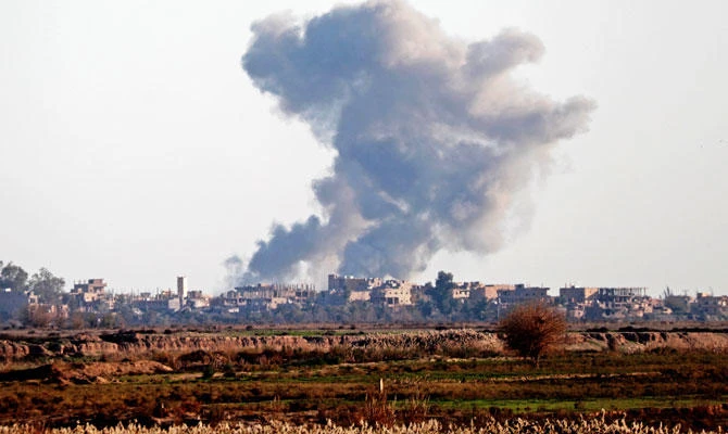 Smoke billows after bombings in the Deir Ezzor province, near Hajin, eastern Syria, on December 15, 2018. (AFP)