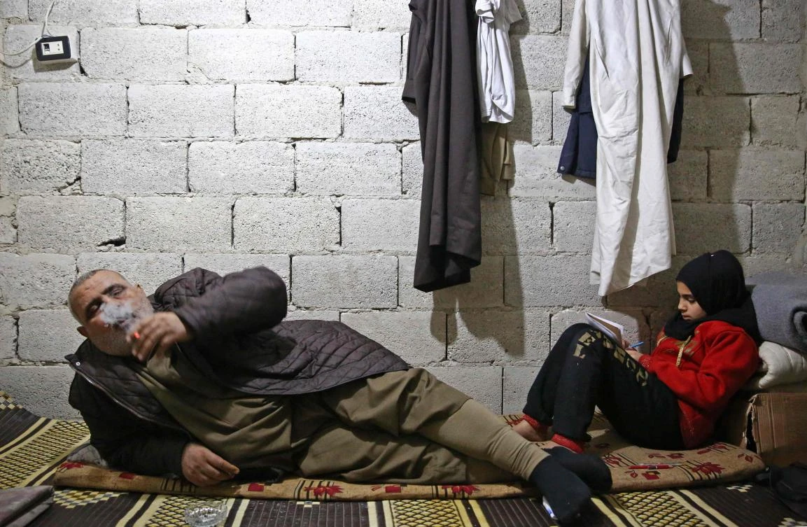A year and a half ago, the basement was a temporary station for displaced people from Deir Ezzor province fleeing the fighting against Daesh, but over time it became home to dozens of people who cannot afford the high living costs in the city. (AFP)
