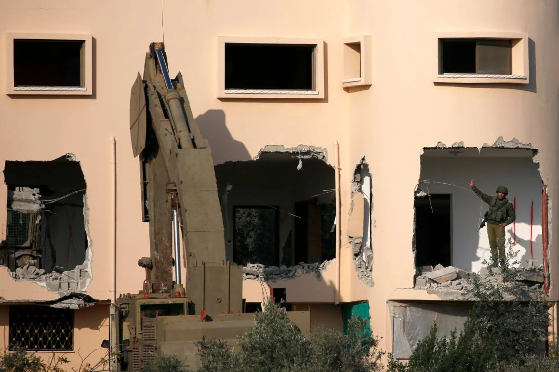The army destroyed the walls of Ashraf Naalwa’s home on the ground and first floors of the house, before withdrawing on Monday morning. (AFP)