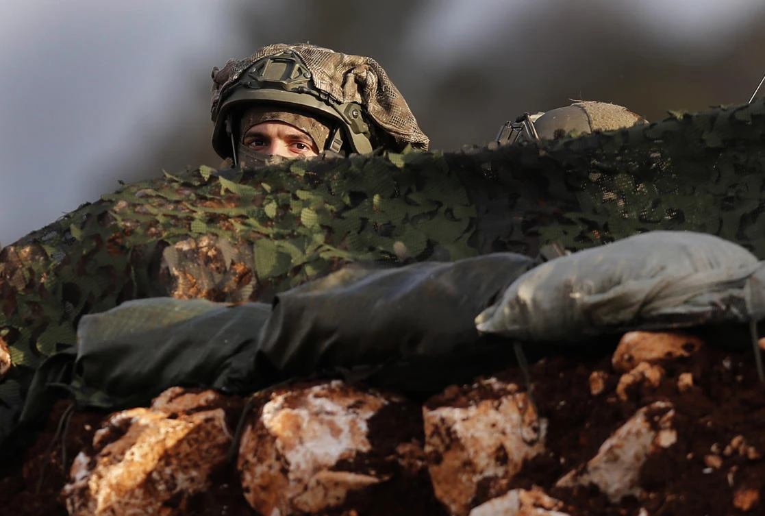 In this Thursday, Dec. 13, 2018 file photo, an Israeli soldier looks out from one of their new positions, near the southern border village of Mays al-Jabal, Lebanon. (AP)