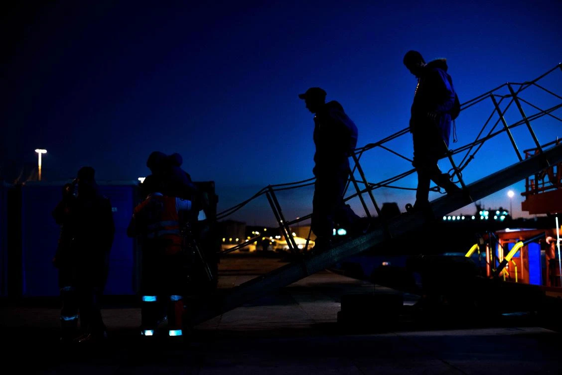 Migrants are transferred upon their arrival onboard a coast guard boat at Algeciras' harbour on November 27, 2018 following their rescue off the Spanish coast. (AFP)
