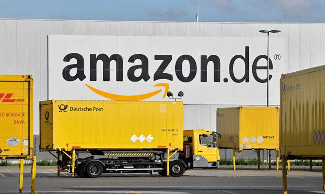 In this file photo dated Wednesday, Nov. 14, 2018, post trucks leave the Amazon Logistic Center in Rheinberg, Germany. (AP)