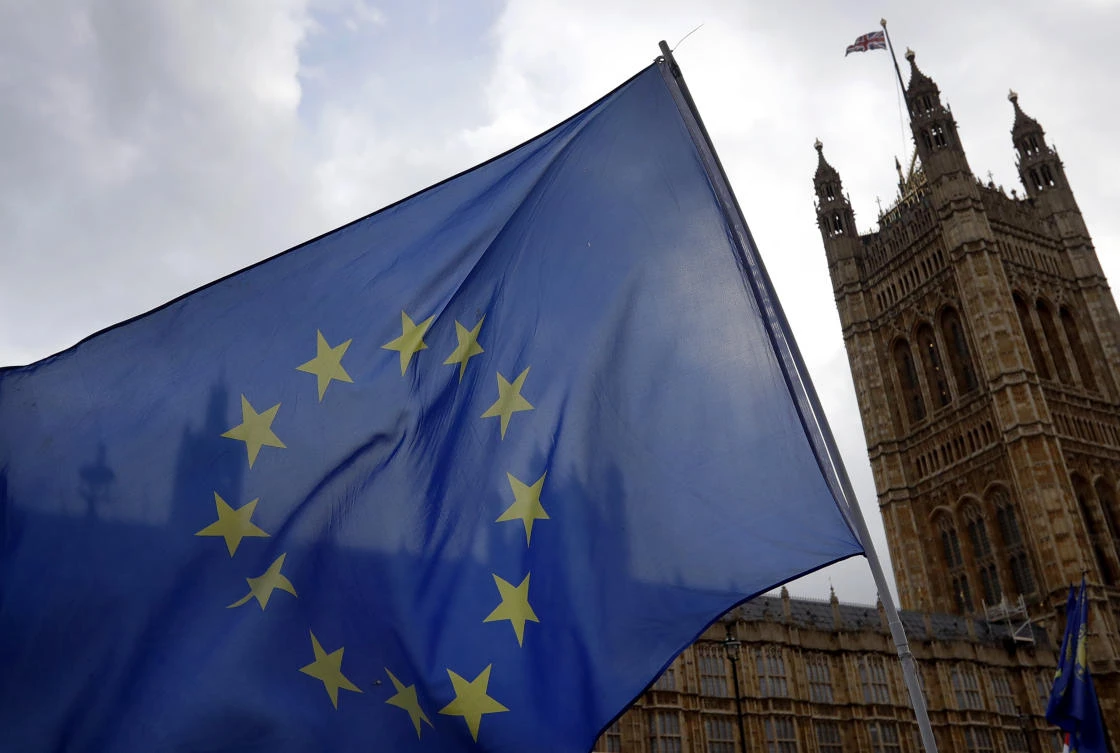 Anti-Brexit campaigners wave a European Union flag in front of parliament in London, Wednesday, Dec. 5, 2018. (AP)