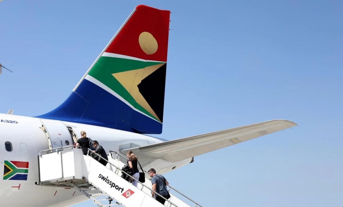 South African Airways (SAA) will be able to offer its customers seats on flights operated by Emirates between South Africa and Dubai. Above, passengers board a SAA plane at Port Elizabeth International Airport, South Africa. (Reuters)