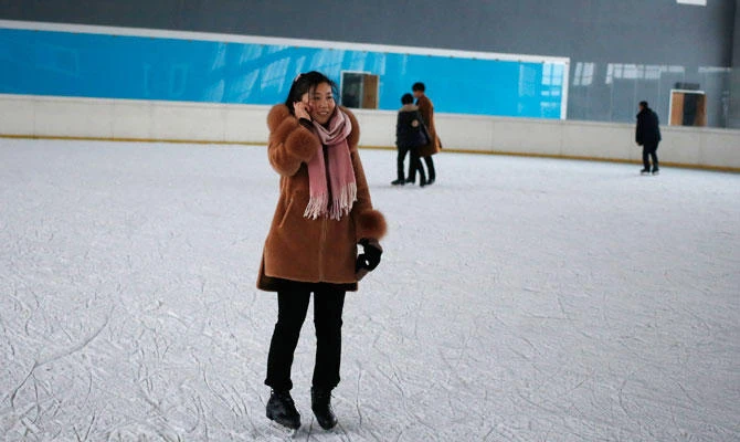 A North Korean woman talks on her mobile phone as she skates on an ice rink in Pyongyang, North Korea Tuesday, Dec. 18, 2018. (AP)