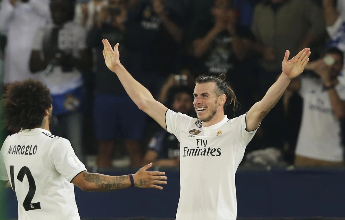 Real Madrid's midfielder Gareth Bale celebrates with teammate Marcelo, left, after scoring his side's third goal during the Club World Cup semifinal against Kashima Antlers in Abu Dhabi. (AP)