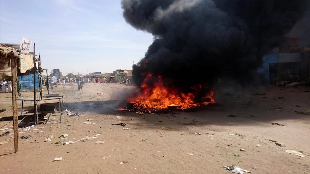 A bonfire is lit along the street during protests against price increases in Atbara, Nile River state in northeastern Sudan December 20, 2018. (Reuters)