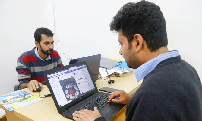 An employee at a photography institute checks his Facebook account in Dhaka, Bangladesh, Thursday, Dec. 20, 2018. (AP)