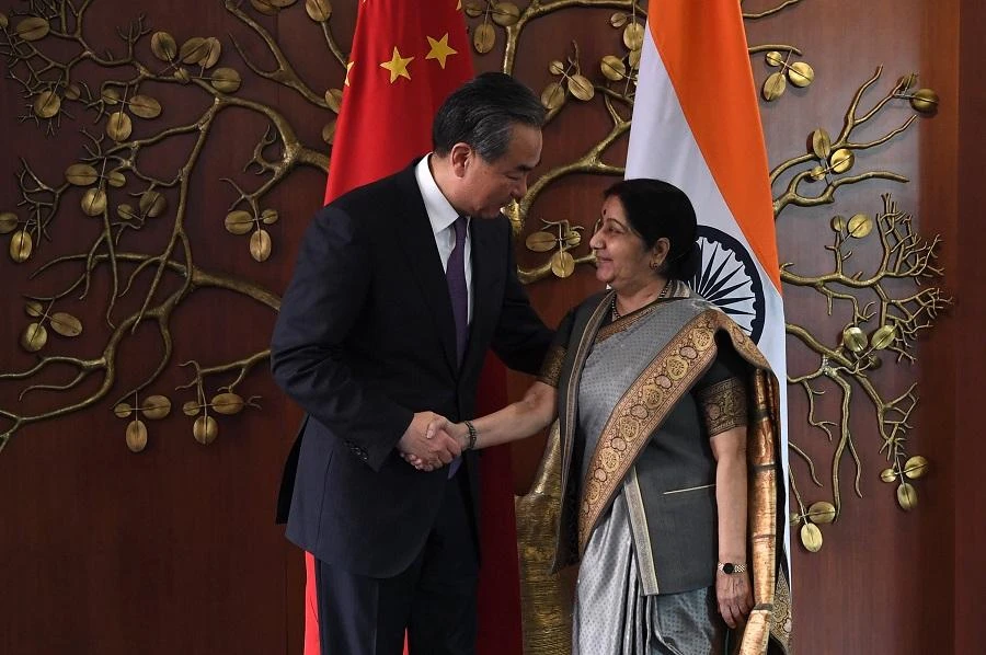 Indian Foreign Minister Sushma Swaraj shakes hands with China’s Foreign Minister Wang Yi prior to a meeting in New Delhi on Dec. 21. (AFP)