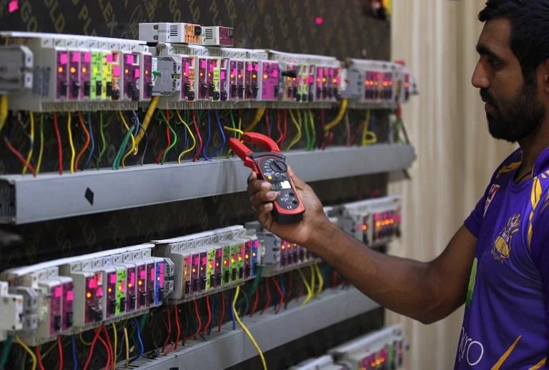 An Iraqi man checks an electric generator supplying homes with electricity in a Baghdad neighbourhood in the Iraqi capital on July 26, 2018. (AFP)
