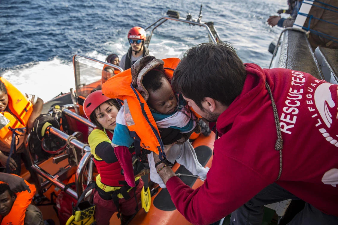 A baby is loaded into the rescue vessel of the Spanish NGO Proactiva Open Arms, after being rescued in the Central Mediterranean Sea at 45 miles (72 kilometers) from Al Khums, Lybia. (AP)