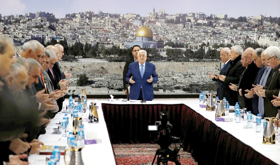 Palestinian President Mahmoud Abbas prays at the start of a meeting in Ramallah, in the West Bank on Sunday. (Reuters)