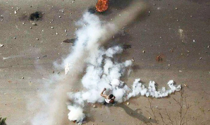 In this Dec. 21, 2018 handout photo provided a Sudanese activist, a protester stands in tear gas during clashes with security forces in Khartoum, Sudan. (AP)