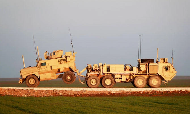 A US Marine Corps tactical vehicle is towed by another near the town of Tal Baydar in the countryside of Syria's northeastern Hasakeh province on December 21, 2018. (AFP)