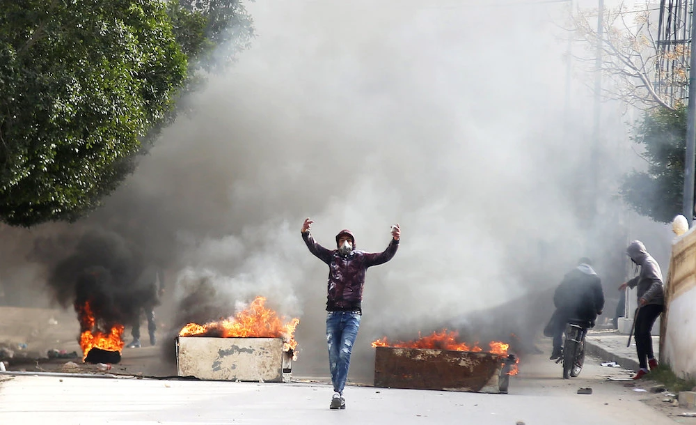 Tunisians clash with police after journalist sets himself ablaze