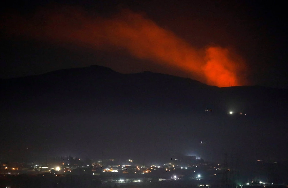 Smoke rises past a mountain as seen from Damascus countryside, Syria December 25, 2018. (Reuters)