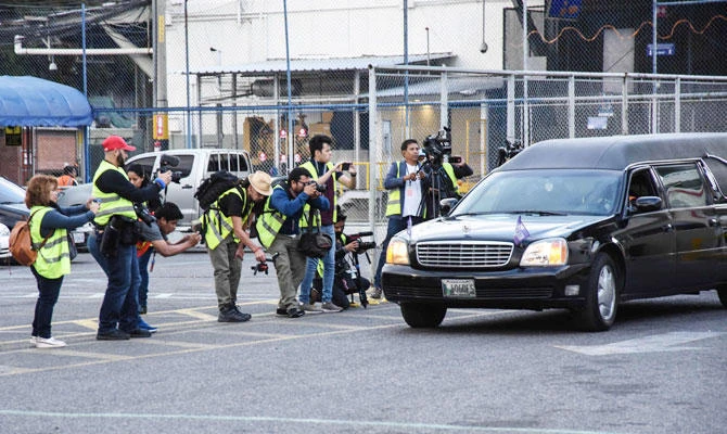 A hearse carrying a coffin with the repatriated remains of seven-year-old Guatemalan migrant girl Jakelin Caal Maquin, who died in a Texas hospital on last December 8, two days after being taken into custody by border patrol agents in a remote stretch of New Mexico desert, drives past journalists upon the remains arrival in Guatemala City before being taken to her native San Antonio Seacortez village, in Raxruha 320 km north of the capital. (AFP)