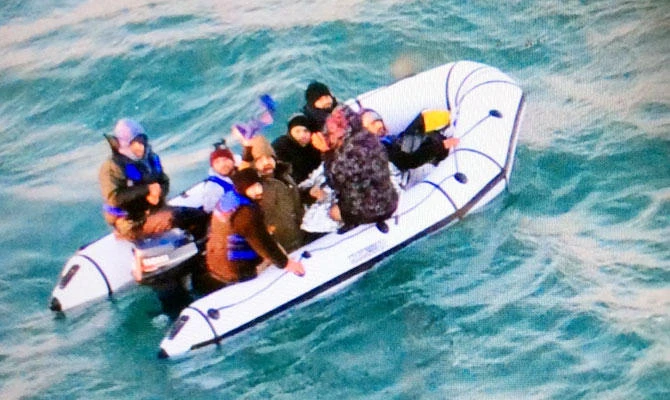 This image provided by the Marine Nationale (French Navy) shows migrants aboard a rubber boat after being intercepted by French authorities, off the port of Calais, northern France, Tuesday, Dec. 25, 2018. (AP)