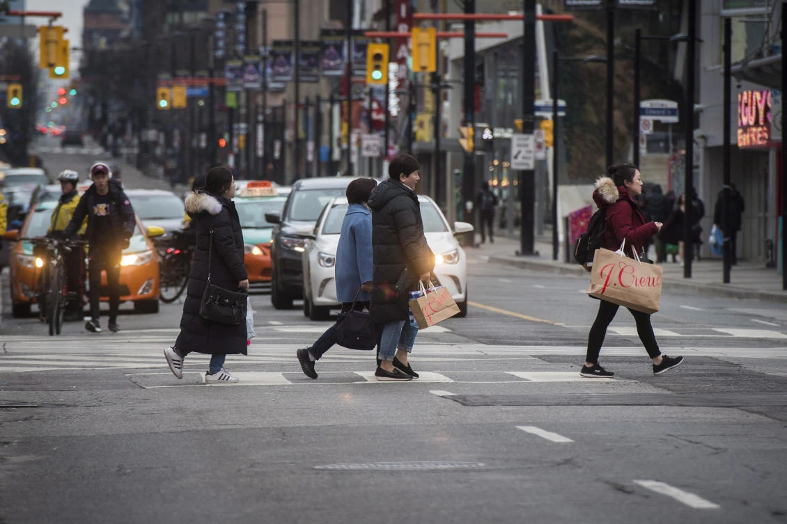 Boxing Day shoppers make their way towards Dundas Square in Toronto on Wednesday, Dec. 26, 2018. (Canadian Press via AP)