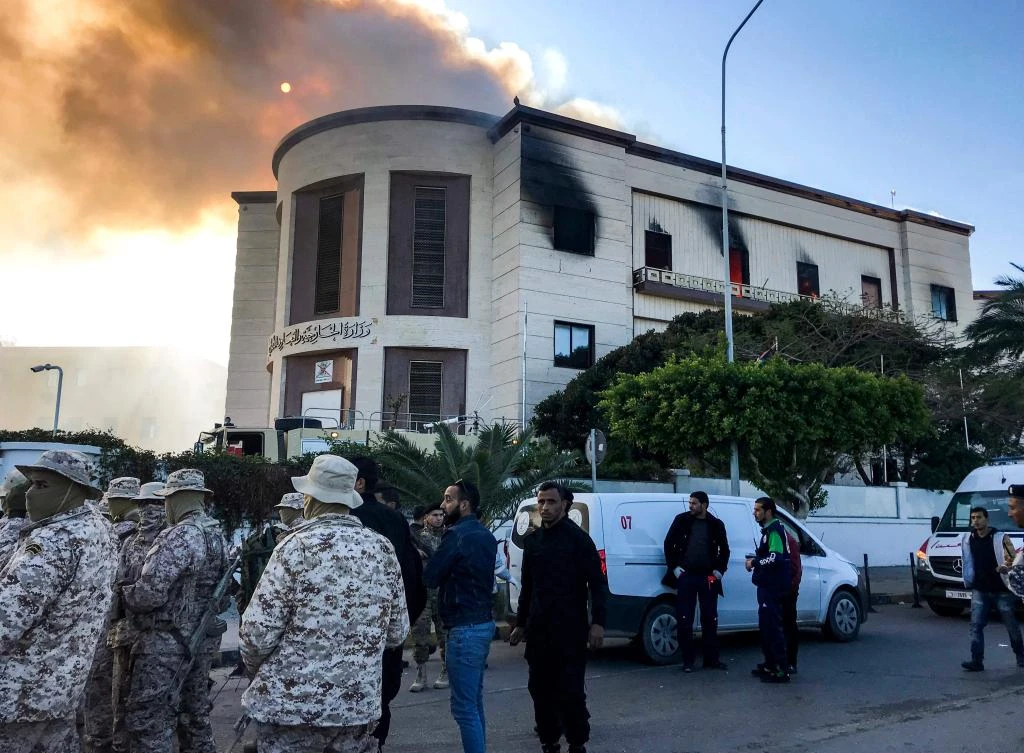 A picture taken on December 25, 2018 shows security officers at the scene of an attack outside the Libyan foreign ministry headquarters in the capital Tripoli. (AFP)
