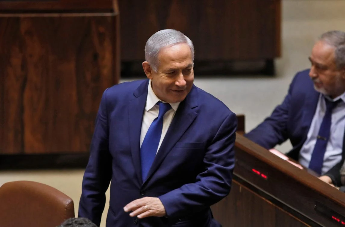 Israeli Prime Minister Benjamin Netanyahu stands next to Israel's former defence minister Avigdor Lieberman during a Knesset (parliament) session in Jerusalem on December 26, 2108.(AFP)